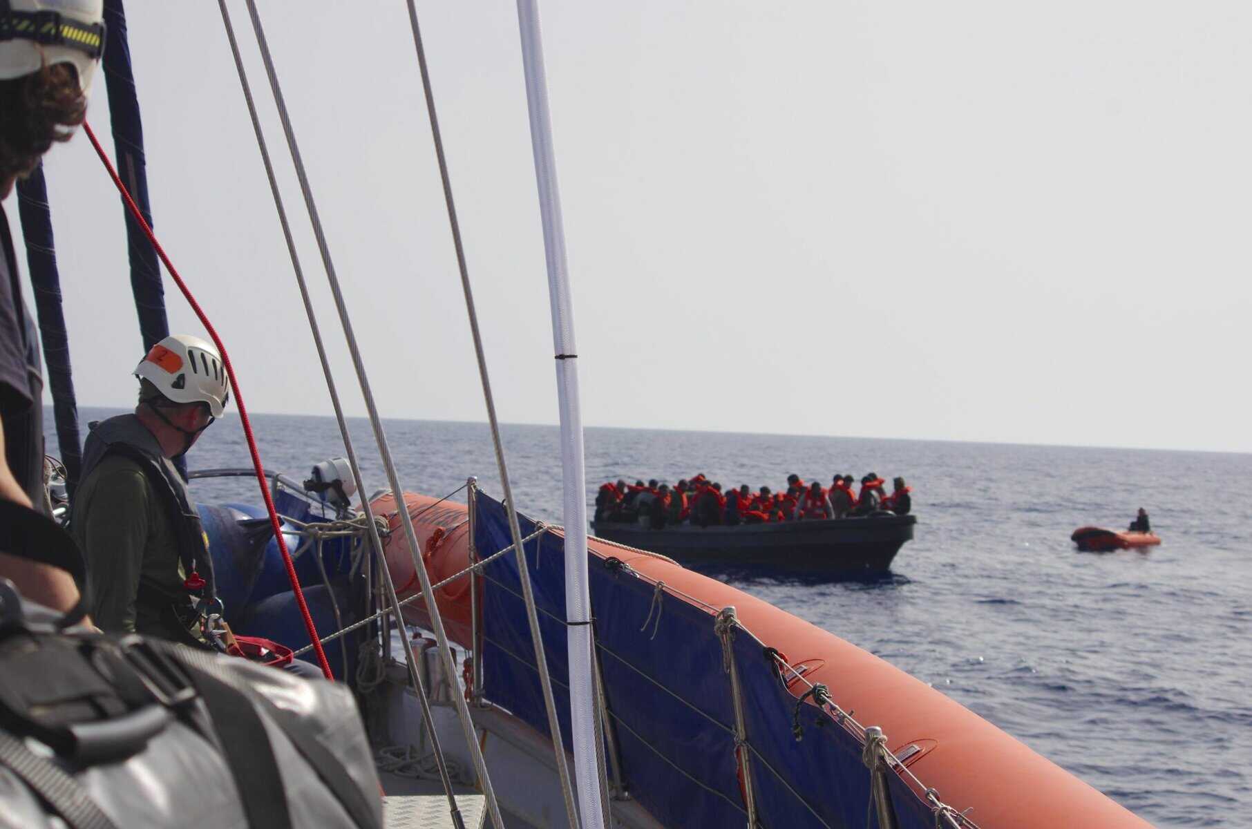 Crew an Bord der NADIR beobachtet den Erstkontakt zwischen Personen auf dem seeuntauglichen Boot und der Crew des NADIR-Tenders